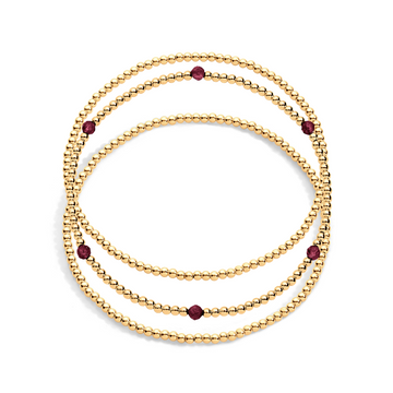 3 gold filled beaded bracelets with one having garnet gemstones