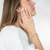 model wearing various mixed metals bracelets and rings