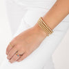 model wearing gold filled beaded bracelets and rings