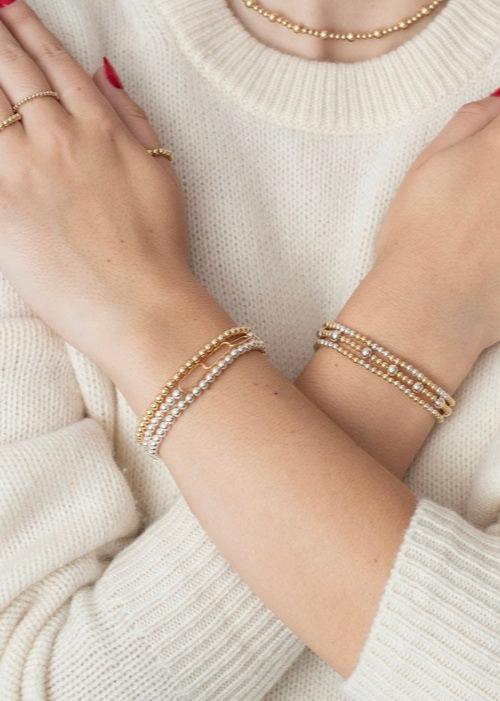 Model wearing mixed metals bracelets and gold filled rings 