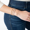 Model wearing 3 gold-filled and mixed metals bracelets